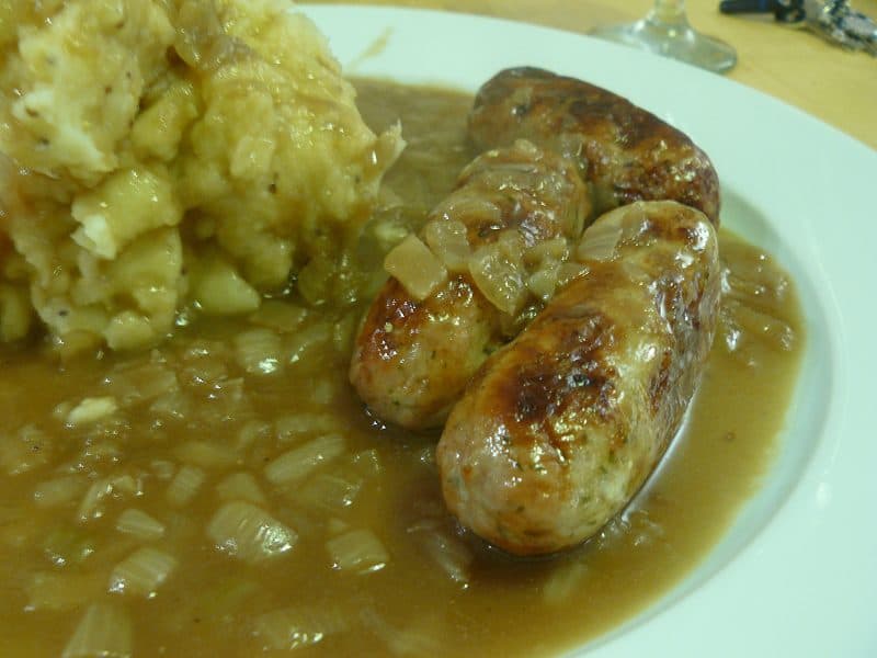 Browned sausages with mashed potato in a glossy onion gravy