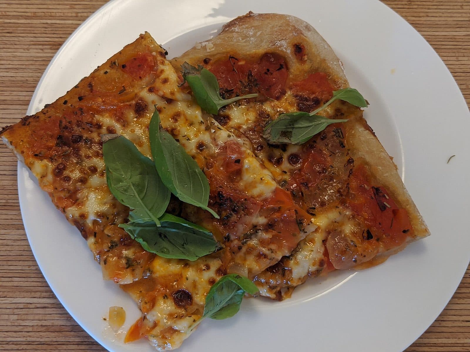 Rectangular margherita flatbread slices with melted mozzarella, tomato and fresh basil