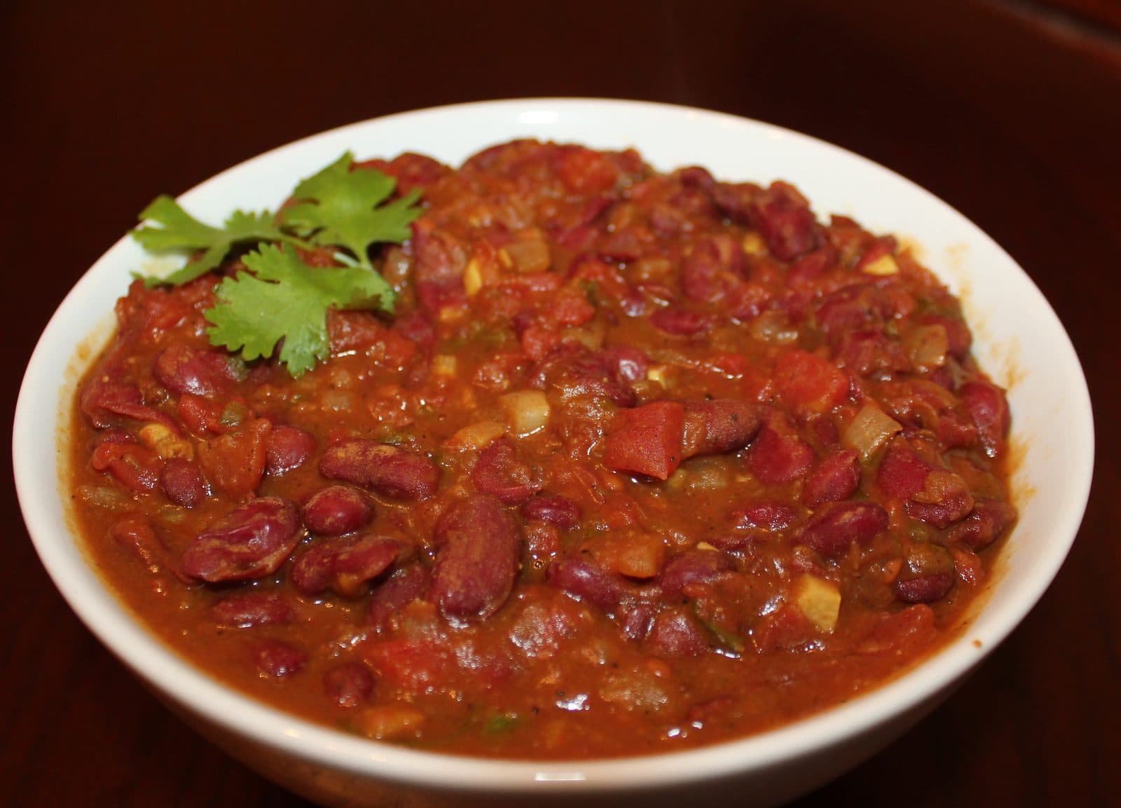 Bowl of rajma (red kidney bean curry) garnished with coriander